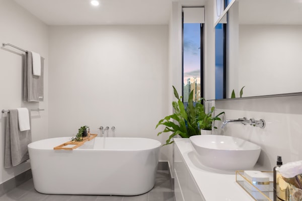 A clean, modern remodeled bathroom with a freestanding tub and vessel sink