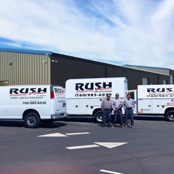 The Rush Plumbing and Rooter crew and service vans